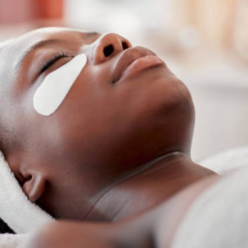 Beauty, relax and eye mask with black woman in spa for skincare, facial treatment and wellness. Health, peace and luxury with girl and face product for cosmetics, dermatology and hospitality